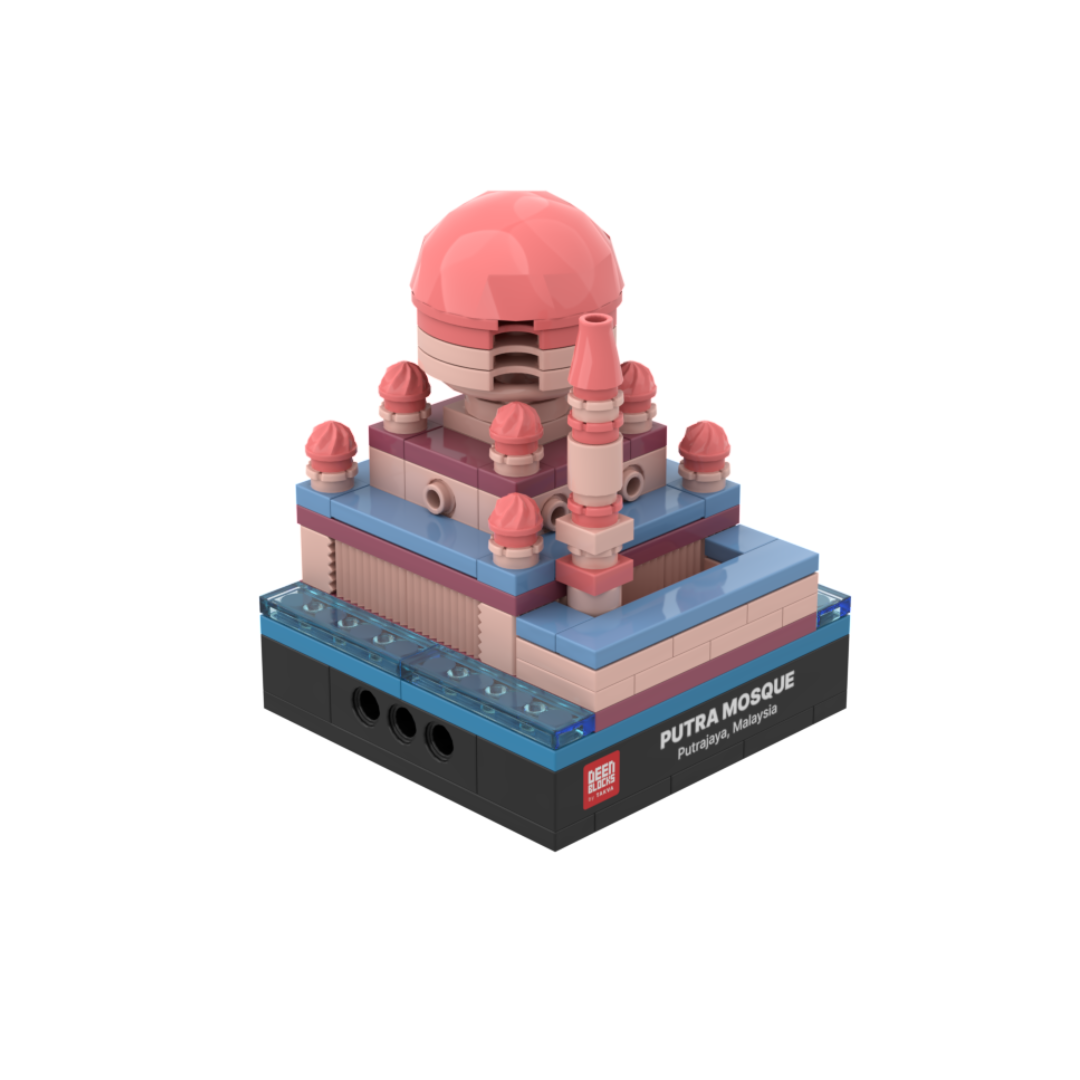 Putra Mosque mini building blocks set, a desk-size Islamic collectible shown at an angle on white, featuring its pink main dome, rose small domes, minaret and blue lakeside base, set on a black DEENBLOCKS nameplate base