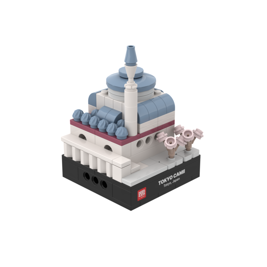 Tokyo Camii mini building blocks set, a desk-size Islamic collectible shown at an angle on white, featuring light blue domes, a white minaret and pink cherry blossom trees, set on a black DEENBLOCKS nameplate base